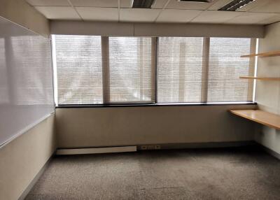A vacant office room with a large window