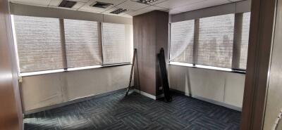 Corner office space with large windows and blinds