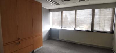 Well-lit office space with large windows and storage cabinets