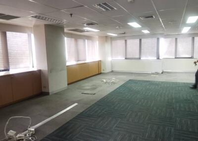 Spacious office with large windows and overhead lighting