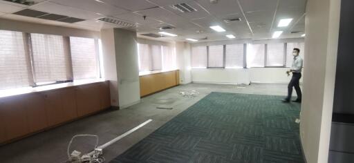 Spacious office with large windows and overhead lighting