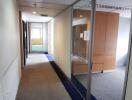 Office hallway with glass partitions and wooden cabinet