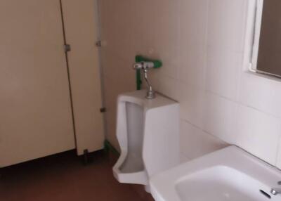 Bathroom with sink, urinal, and cubicle