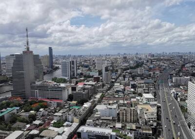 Aerial view of an expansive cityscape with high-rise buildings and a river