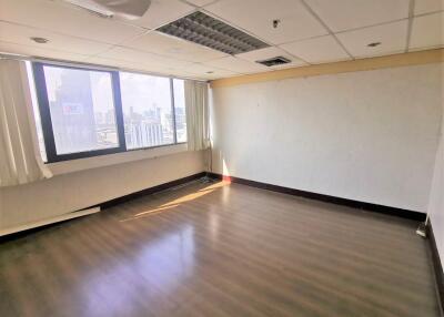 Vacant room with large windows and cityscape view