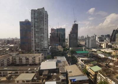 View of cityscape with tall buildings and construction cranes