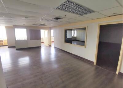 Spacious office area with large windows and glass partition