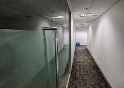 Office hallway with glass doors and carpeted floor