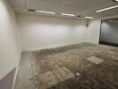 Empty office space with exposed flooring