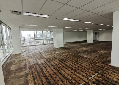 Unfinished office space with large windows