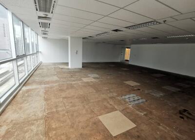 Spacious unfurnished commercial area with large windows and natural lighting