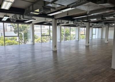 Spacious open-plan office with large windows and modern features