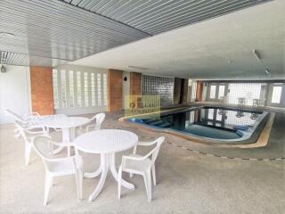 Indoor swimming pool area with seating