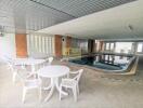 Indoor swimming pool area with seating