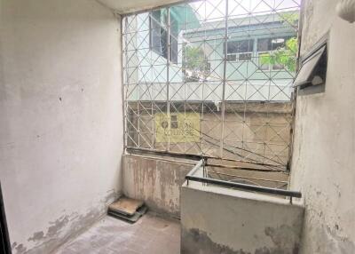 Partially covered balcony with metal security grilles