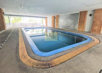 Indoor swimming pool with lounge chairs