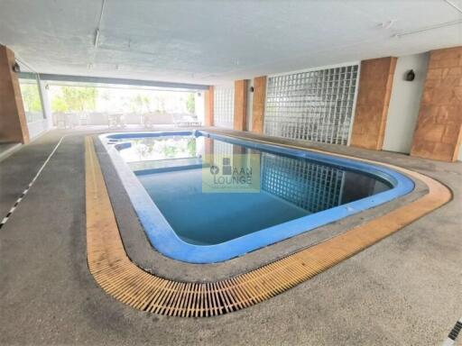 Indoor swimming pool with lounge chairs