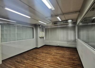 Spacious office with large windows and wooden flooring