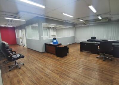 Spacious office with wooden flooring and modern furniture