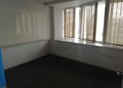 Small empty room with whiteboard and windows with blinds