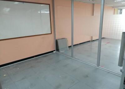 Vacant office space with glass partitions and a whiteboard