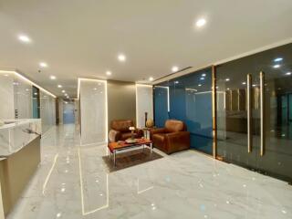 Modern lobby with sleek marble flooring and leather seating