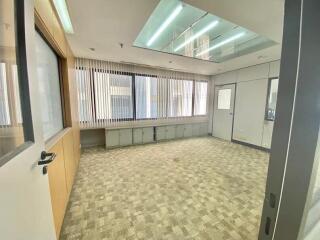 Empty office space with carpeting and large windows