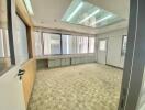 Empty office space with carpeting and large windows