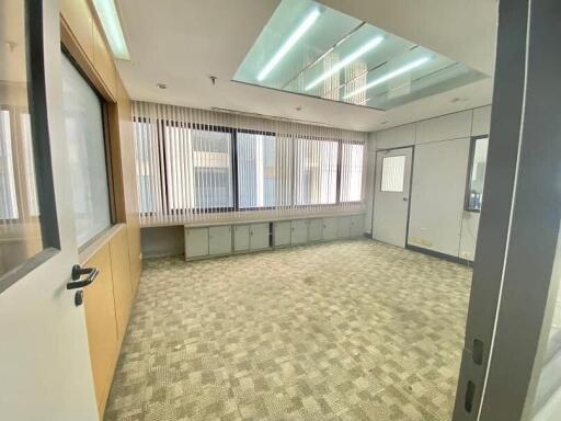 Empty office space with carpeting and large windows