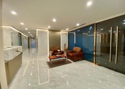 Modern lobby with seating area and marble flooring