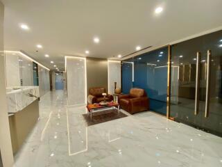 Modern lobby with seating area and marble flooring