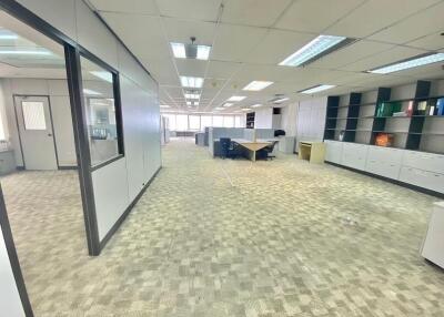 spacious and well-lit office space with cubicles and storage