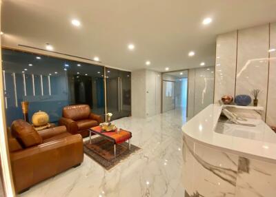 Modern living room with marble flooring and leather furniture