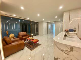 Modern living room with marble flooring and leather furniture