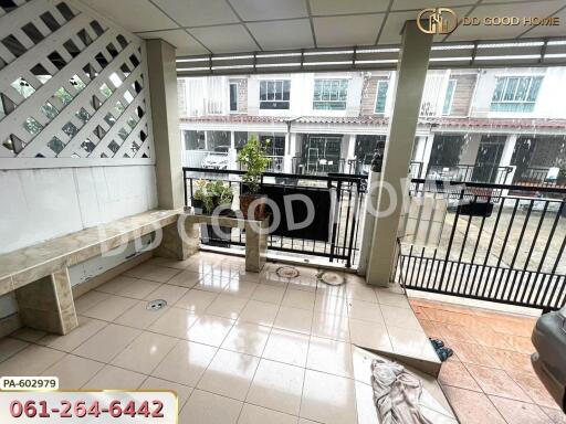 Spacious balcony area with tiled flooring and seating