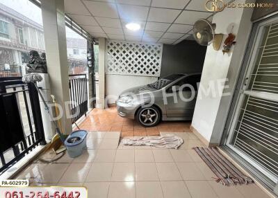 Carport with car and tiled floor