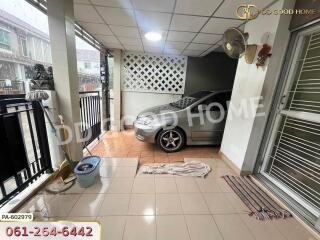 Carport with car and tiled floor