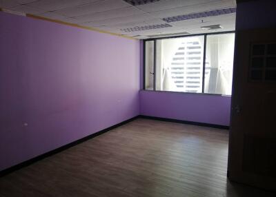 Empty room with purple walls and wooden flooring