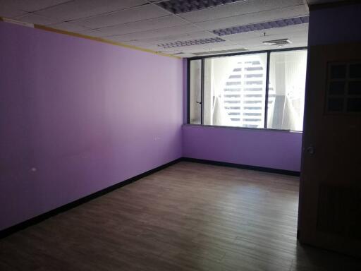 Empty room with purple walls and wooden flooring