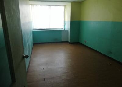 Empty bedroom with large window and two-tone walls