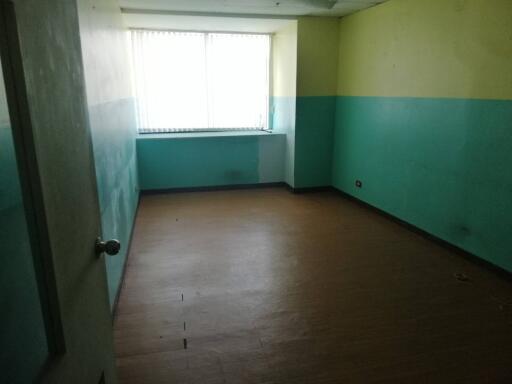 Empty bedroom with large window and two-tone walls