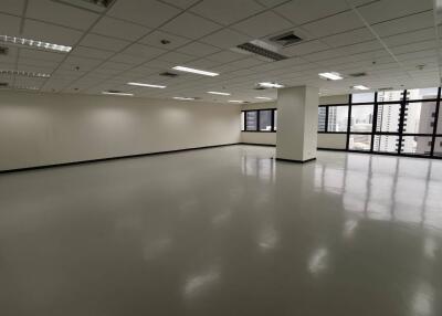 spacious commercial office space with large windows and modern lighting