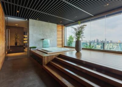luxurious indoor spa area with hot tub and city view