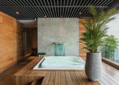 Modern bathroom with hot tub and indoor plant