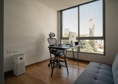 Home office with a large window and city view