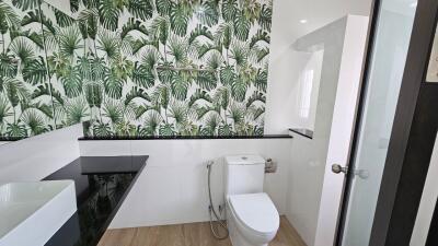 Modern bathroom with nature-themed wall tiles