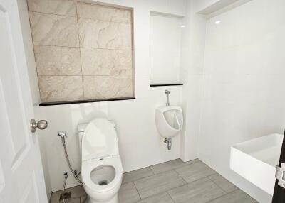 Modern bathroom with toilet, urinal, and sink