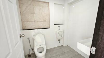 Modern bathroom with toilet, urinal, and sink