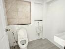 Modern bathroom with toilet, urinal, and sink