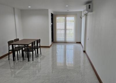 Minimalist dining area with table and four chairs